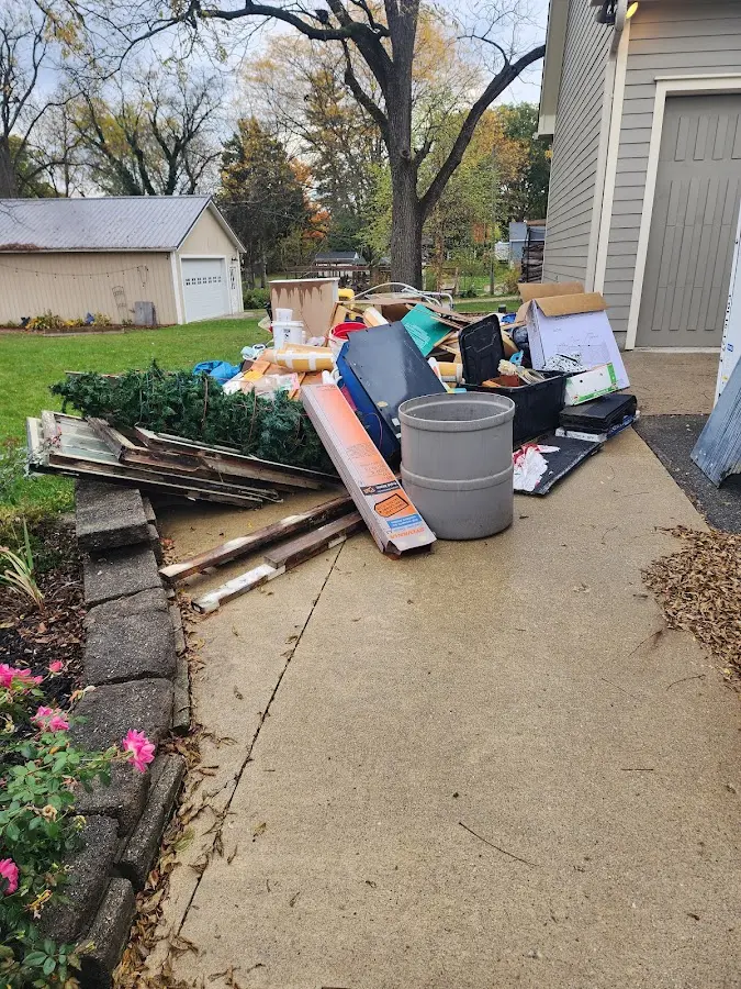Dumpster being loaded with debris for Roofing Dumpster Rental in International Falls